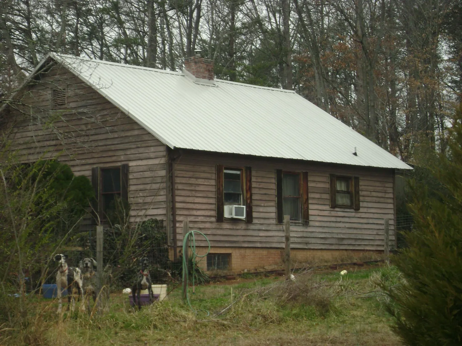 White metal roof on an old wood sided farmhouse, from a Asphalt Shingle Roof Repair job in Dry Branch